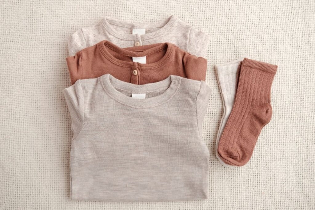 folded baby clothing - donate supplies