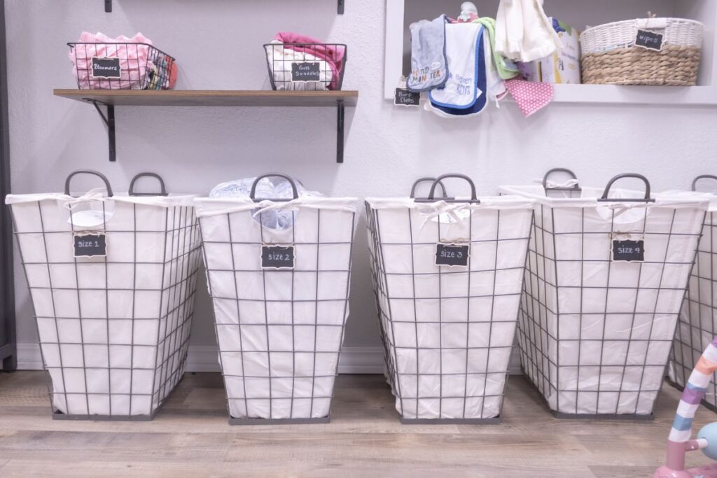 Containers with diapers and baby supplies on shelf