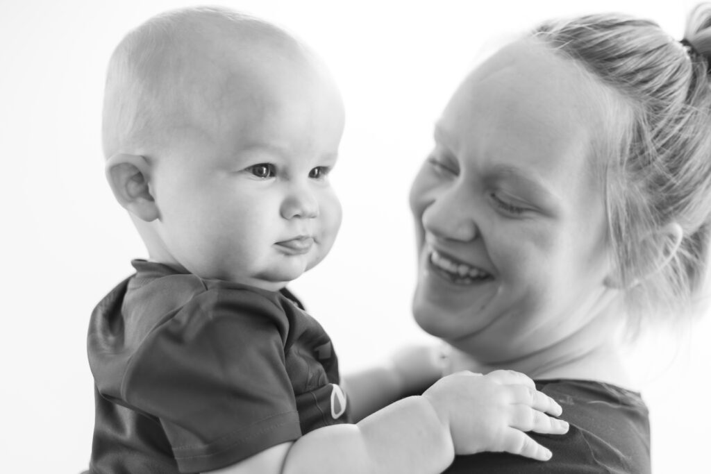 Mom holding her baby smiling